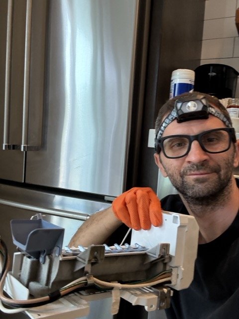 Spark Appliance Repair technician diagnosing a refrigerator in a San Diego home