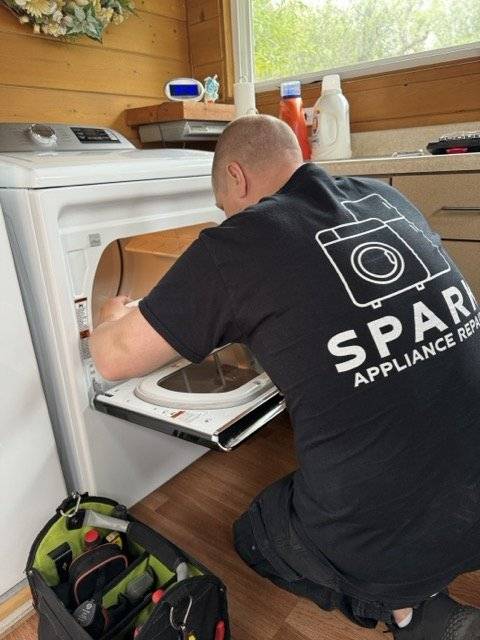 Spark Appliance Repair technician servicing a refrigerator in a San Diego home