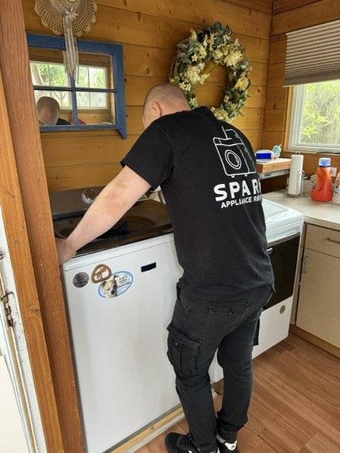 Spark Appliance Repair technician working on an LG front-load washing machine in San Diego