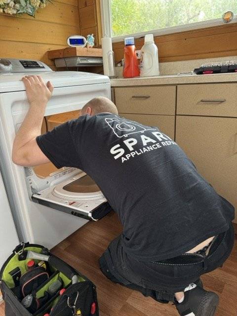 Spark technician servicing a front-load washer in San Diego
