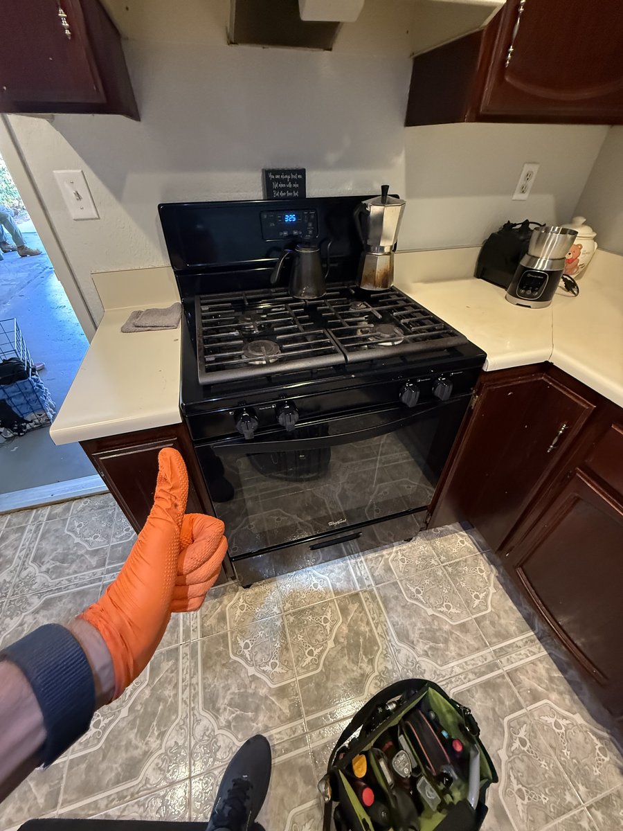 Yurii assessing a gas range with ignition issues in a San Diego home — a common oven and stove repair call