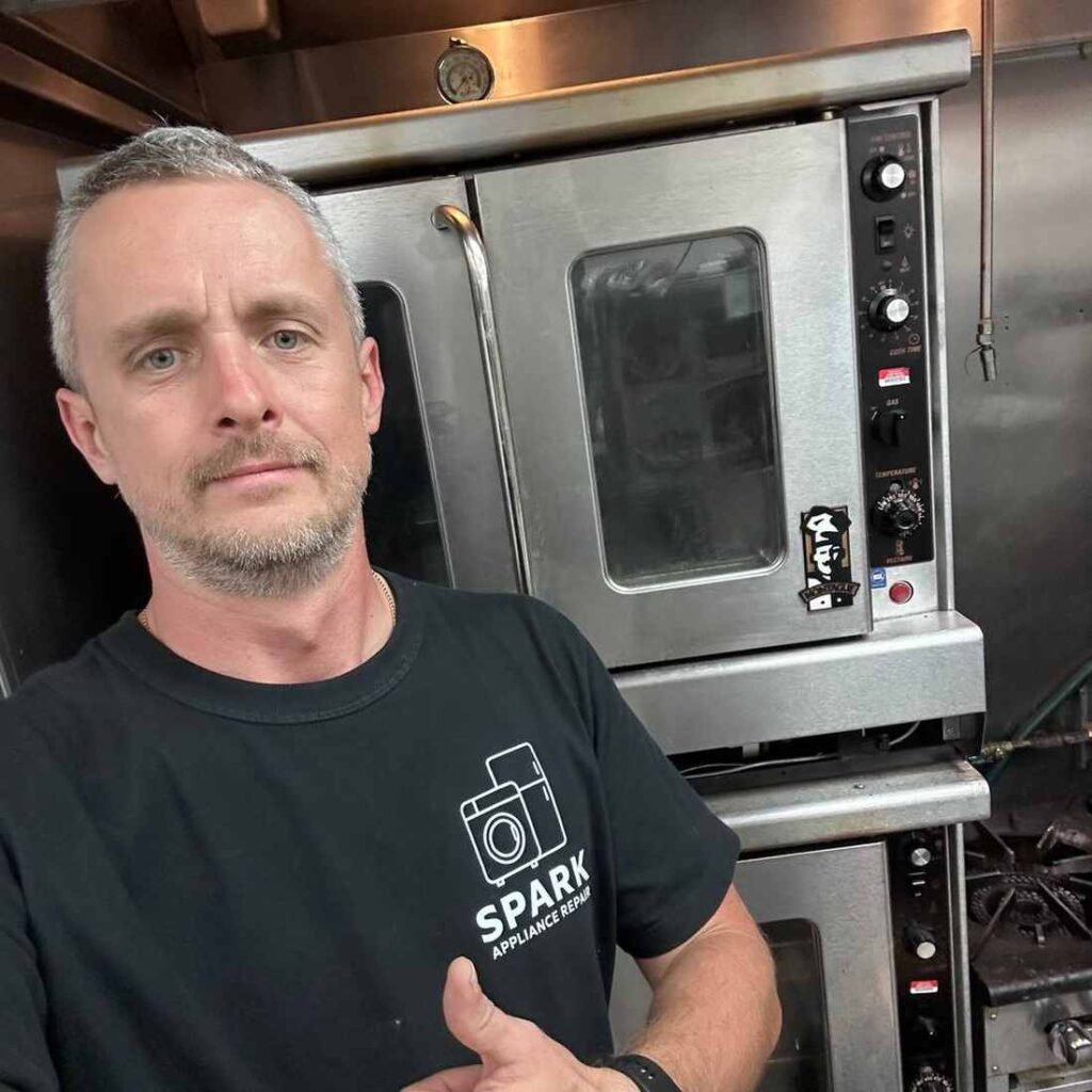 Spark Appliance Repair lead technician Yurii at a commercial gas convection oven in San Diego