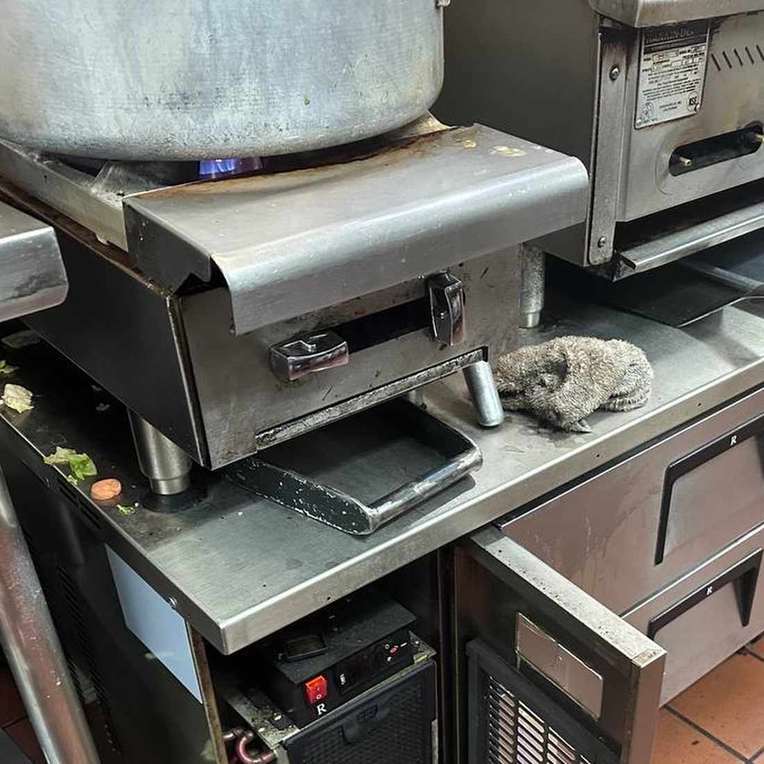Commercial charbroiler, open burner and griddle on a San Diego restaurant cook line serviced by Spark Appliance Repair