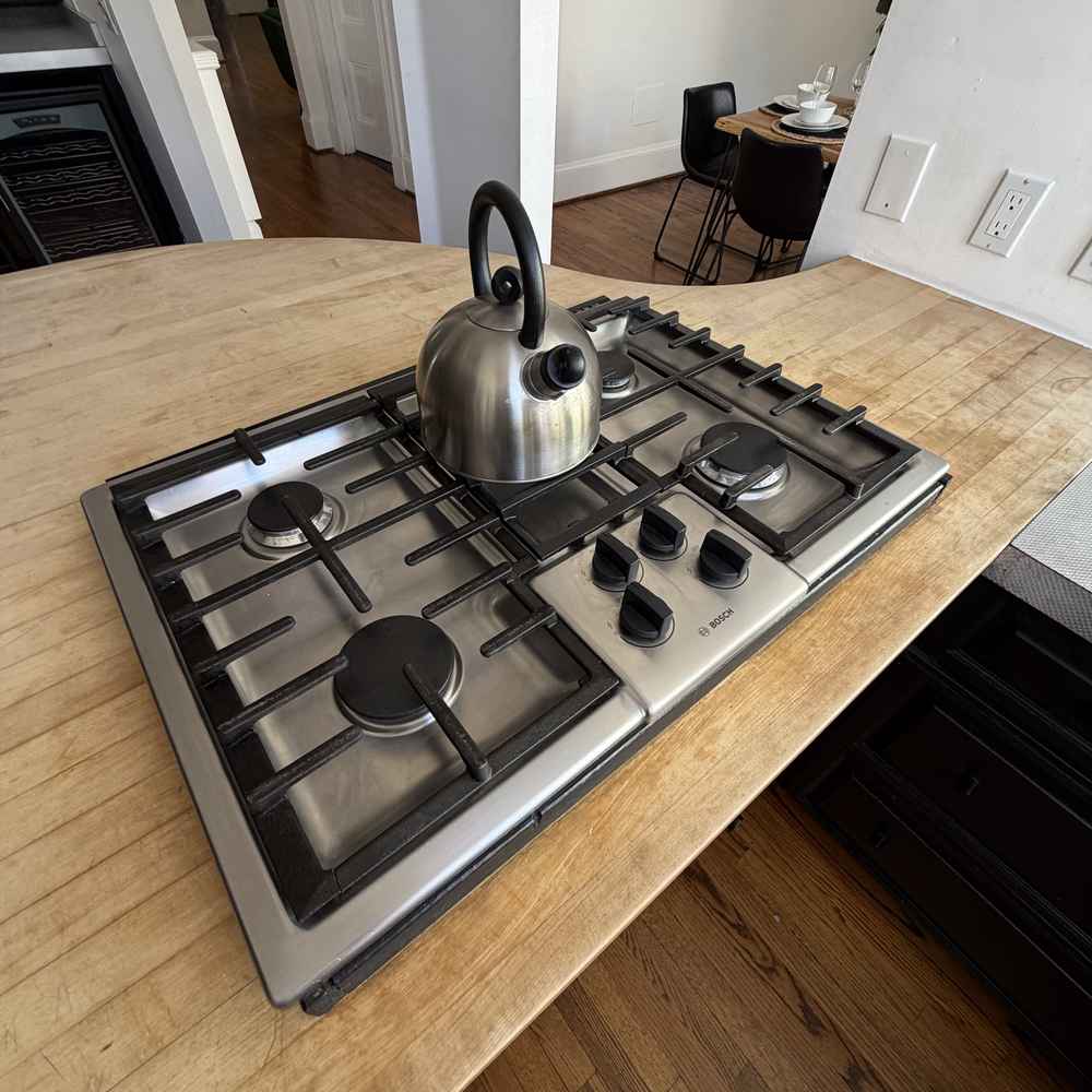 Bosch sealed-burner gas cooktop set into a wood island countertop, surface only, San Diego &mdash; Spark Appliance Repair