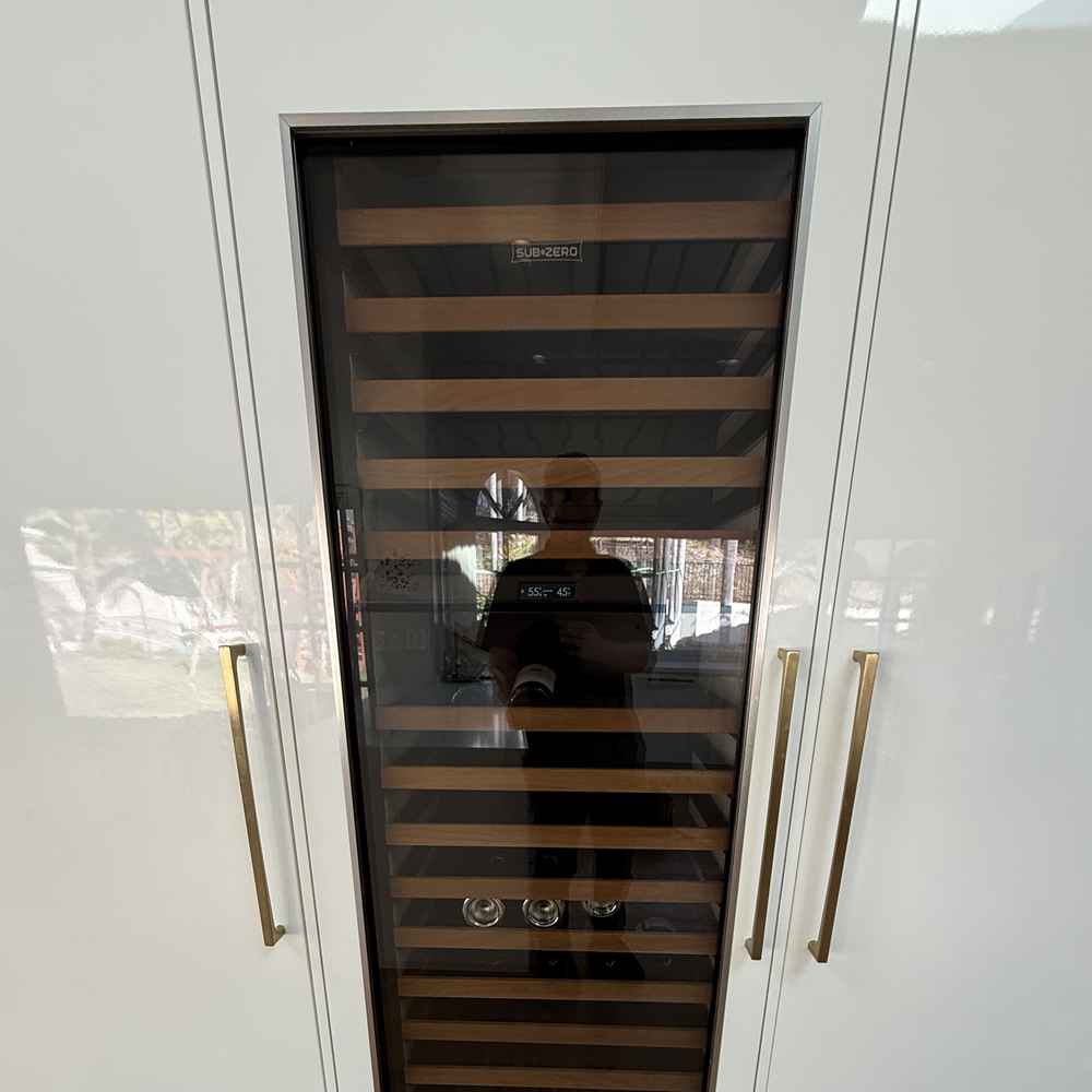 Built-in panel-ready Sub-Zero wine column with wood shelves in a San Diego kitchen &mdash; Spark Appliance Repair