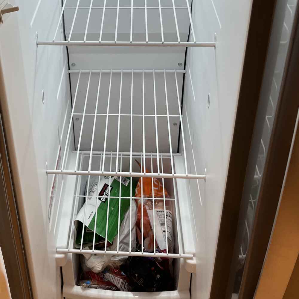 Frost-free freezer interior with wire shelves and frozen-food storage, serviced in San Diego &mdash; Spark Appliance Repair