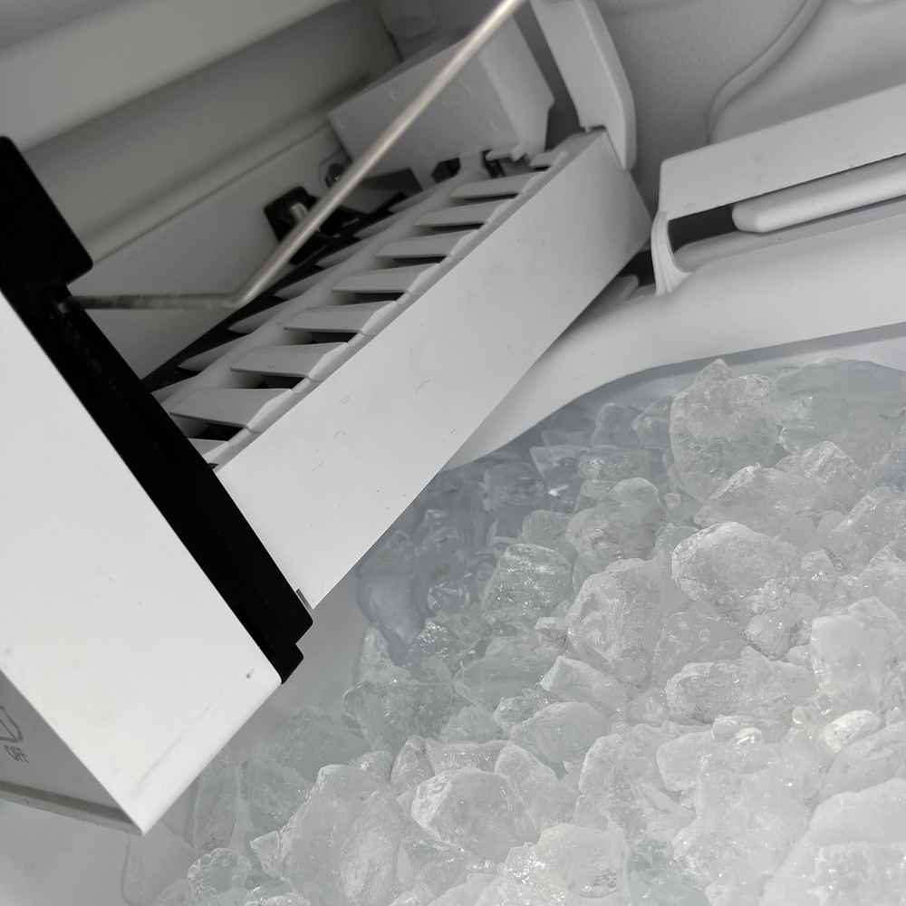 Ice-maker module dropping fresh ice cubes into the bin during a San Diego service call — Spark Appliance Repair