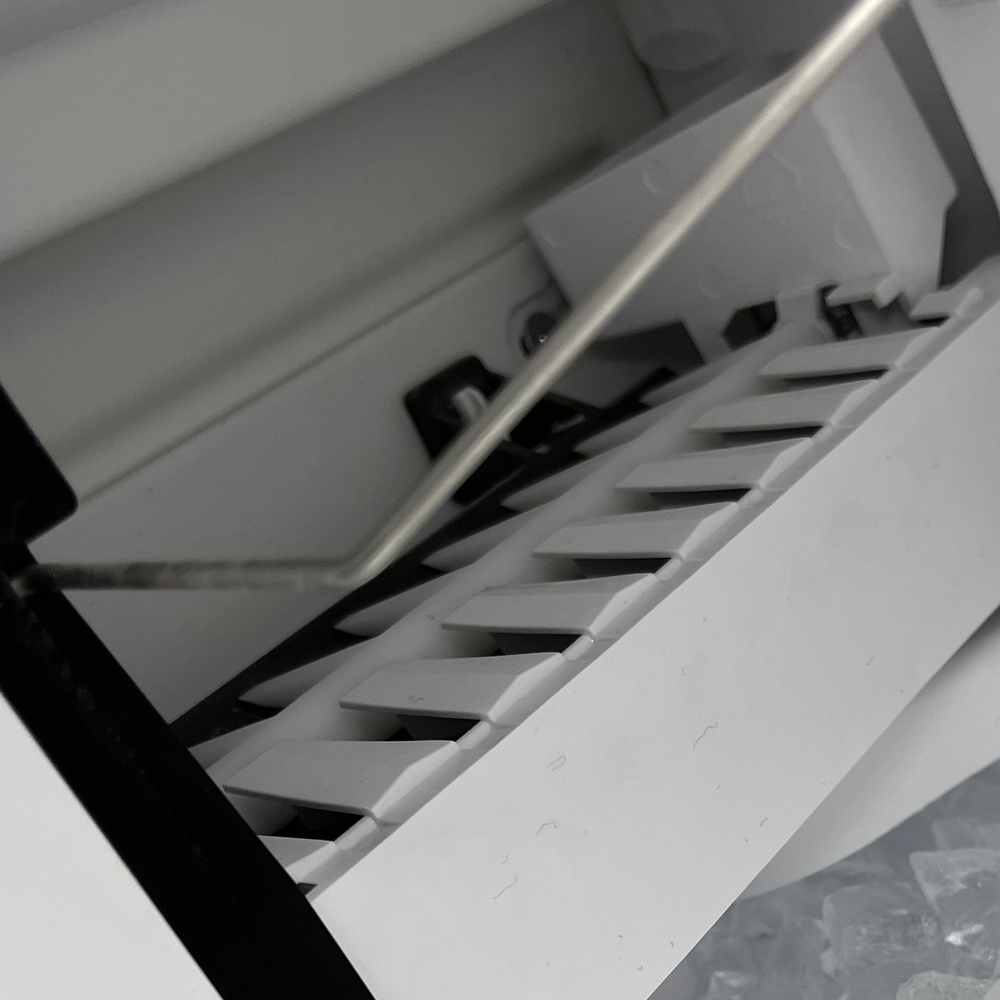 Close-up of an ice-maker mold and wire shut-off arm during repair in San Diego — Spark Appliance Repair