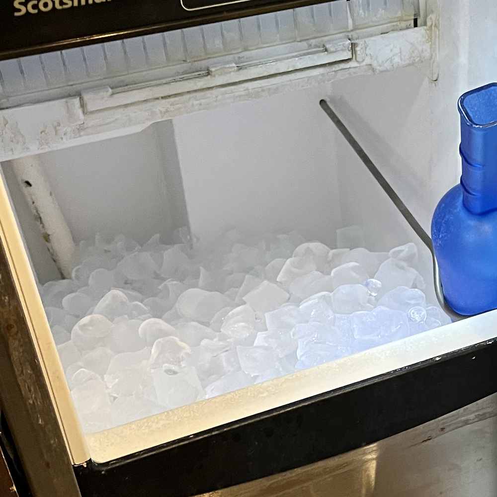 Bin of clear ice cubes inside a Scotsman under-counter ice machine repaired in San Diego — Spark Appliance Repair