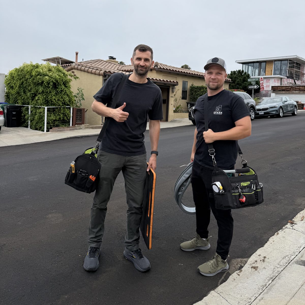 Spark Appliance Repair technicians with tool bags on a service call in San Diego