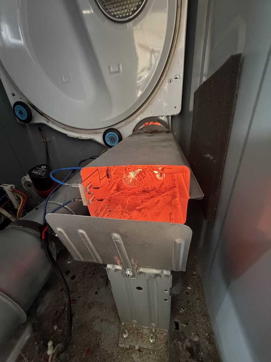Dryer heating element glowing orange inside the open heater box during a live test — Spark job photo