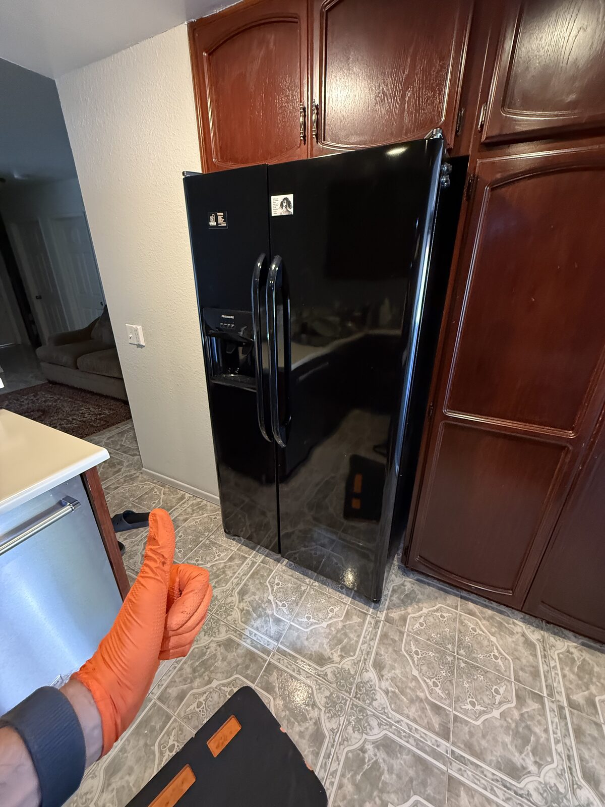 Black Frigidaire side-by-side refrigerator with a door water and ice dispenser in a kitchen on a Spark service call