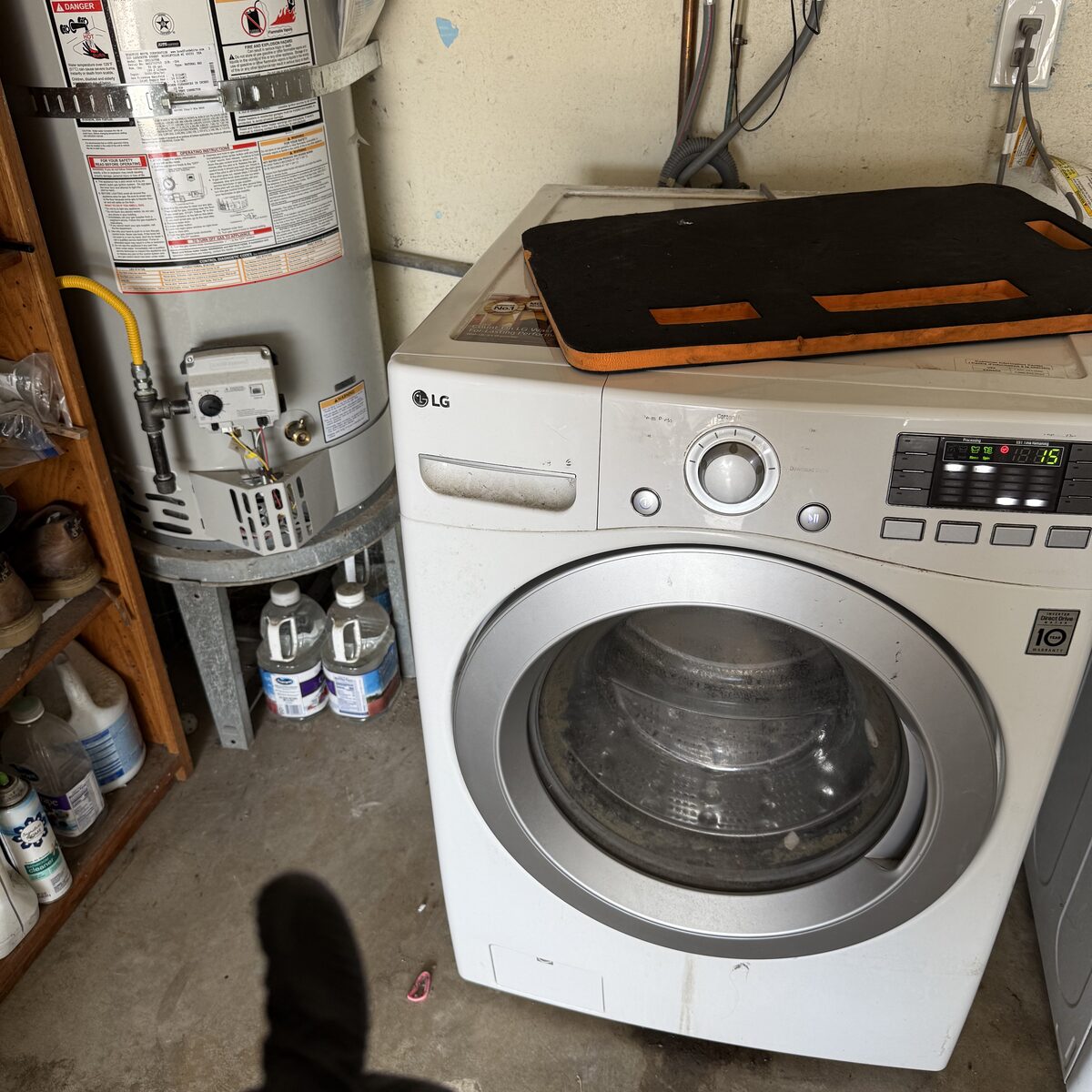 White LG front-load washer in a Chula Vista garage on a Spark Appliance Repair drain call