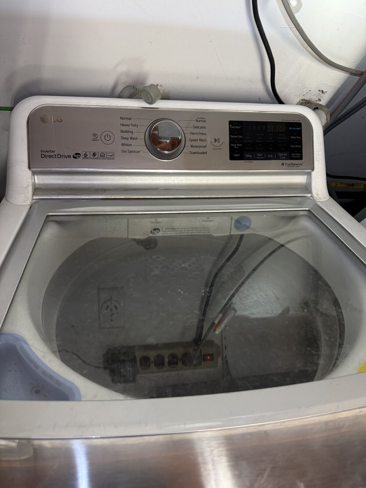 LG Direct Drive top-load washer with the lid open during a Spark service visit