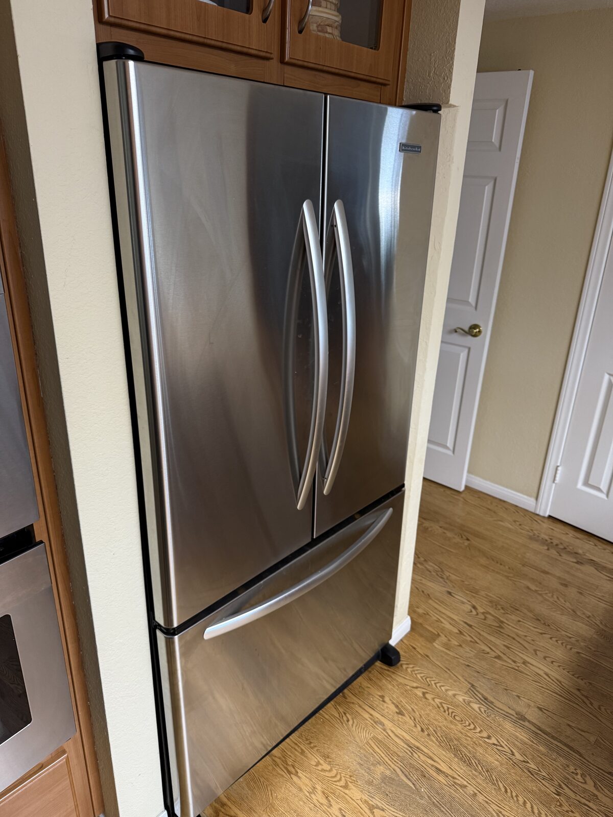 Stainless KitchenAid French-door refrigerator with a bottom freezer drawer in a kitchen