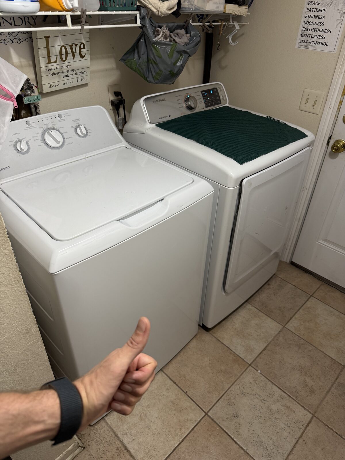 Top-load washer beside a Samsung dryer in a tiled laundry room after a Spark service visit